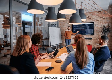 In a corporate setting businessman leads a meeting, passionately presenting a business plan to his attentive team, fostering collaboration and strategic thinking - Powered by Shutterstock