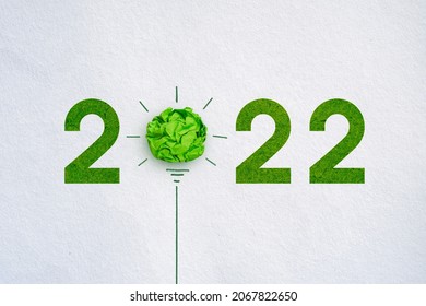 Corporate Social Responsibility (CSR), eco-friendly business and environmental 2022 concept, Green crumpled paper light bulb on white background