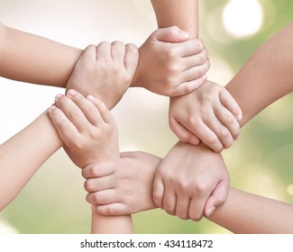 Corporate Social Responsibility CSR On Children's Friendship Education, Teamwork Empowerment And Go Green Concept With Kids And Friends Holding Hands Together Isolated On Natural Background  