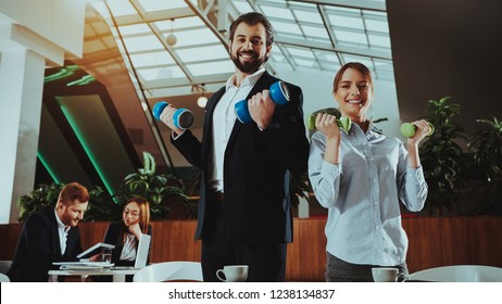 Corporate Sport Lifestyle. Healthcare Of Business People. Office Workers Working With Dumbbells. Workers Doing Fitness Exercises. Yoga Practice. Employee Man Smiling To Healthy Woman.