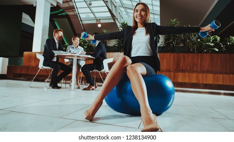 Corporate Sport Lifestyle. Healthcare Of Business People. Worker Relax In Office . Yoga Practice. Happy Office Manager. Woman Balance On Ball With Dumbbells . Girl Stretching On Work.