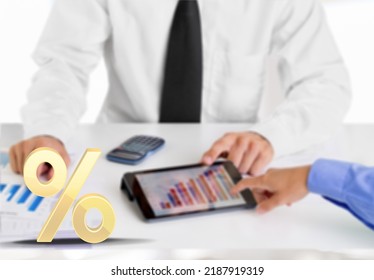 Corporate Tax And Interest Rate. Percent Sign Standing On Table On Background Of Serious Busy Person Counting On Calculator. Concept Of Interest Calculation.