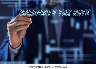 Corporate Tax Rate. Man Writing On Virtual Screen Against Color Background, Closeup