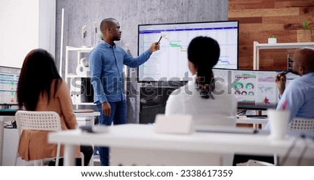 Corporate Training Presentation In Classroom With Computers