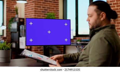 Corporate worker typing on computer with greenscreen monitor, working with blank chroma key display and isolated copyspace template. Using desktop pc with mockup background on screen. - Shutterstock ID 2174911535