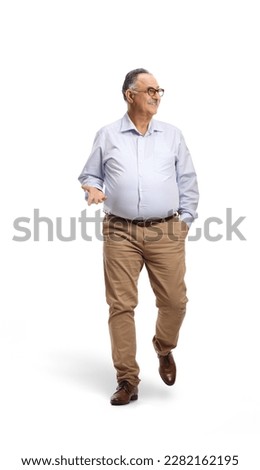 Corpulent mature man walking towards camera and looking to the side isolated on white background