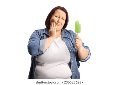 Corpulent woman with a lollipop ice cream holding his cheek and having a toothache isolated on white background - Shutterstock ID 2365236287
