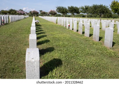 Corpus Christi, Texas, USA-July 18, 2021: Grave Markers In A Row Casting Shadows On The Ground The The Coastal Bend State Veterans Cemetery In Corpus Christi, Texas. 