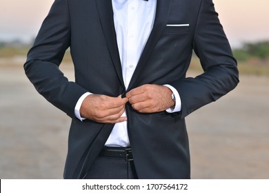 Correct button on jacket, hands close-up, dressing, man's style, stylish man. Businessman luxury style. Elegant young handsome man. Men's jacket, hand cover the button. Business style.