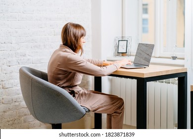 The Correct Position Posture When Working At The Computer. A Woman Sits At A Table With A Laptop Computer. Spinal Curvature. Good Posture. Healthy Back.