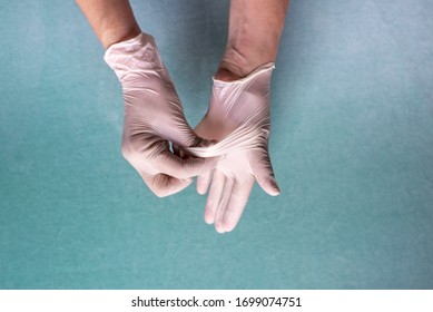 Correct Way To Remove Latex Gloves To Prevent Coronavirus On A Green Background