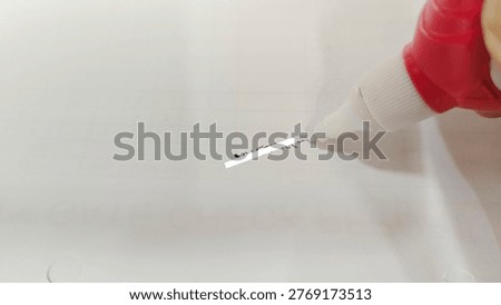 Correcting Errors: Whiteout Pen Covering Handwritten Text.