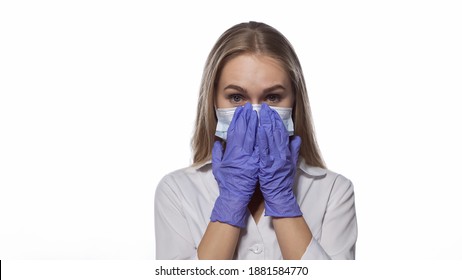 Correcting Medical Face Mask Young Nurse With Long Straight Hair Looking At The Camera Wearing White Medical Uniform Isolated On White Background. 