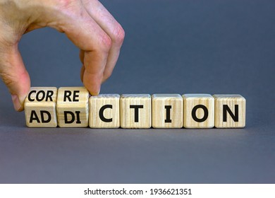 Correction addiction symbol. Businessman turns wooden cubes and changes the word 'addiction' to 'correction'. Beautiful grey background. Business, correction addiction concept. Copy space.