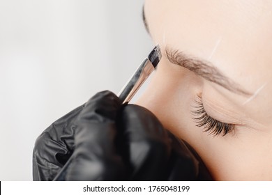 Correction And Tint Of Eyebrows, Master Applies Brush To Woman Marking On Brow.