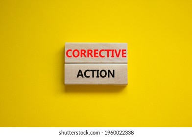 Corrective action symbol. Wooden blocks with words 'Corrective action' on beautiful yellow background. Business and Corrective action concept. Copy space.