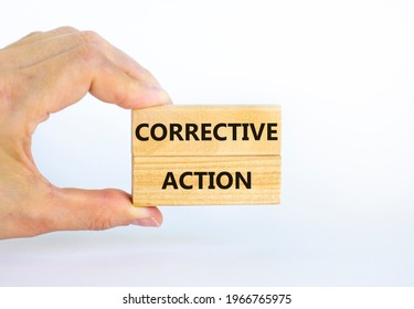 Corrective action symbol. Wooden blocks with words 'Corrective action' on beautiful white background. Businessman hand. Business and Corrective action concept. Copy space.