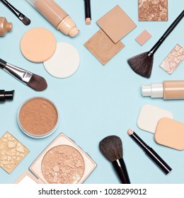 Corrective makeup set. Concealers, primer, liquid fluid and cream foundation with correcting, bronzing, highlighting, shimmer powder, make-up brushes and sponges. Flat lay, copy space