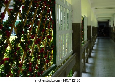 The Corridor Between The Buildings On The Side Is A Bamboo Lattice With Rose Vines Lattice With White Wooden Battens.