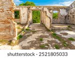 Corridor leading to what could be a garden in the ruins of the former Carabinier Barracks of the Spain