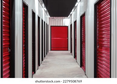 Corridor of self storage unit with red doors. Rental Storage Units