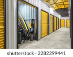 Corridor of self storage unit with yellow doors. Rental Storage Units