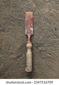 Corroded chisel. A chisel is a carpentry tool in the form of an iron blade that is sharp at the end to make holes or carve hard objects such as wood, stone or metal. - Shutterstock ID 2347516709