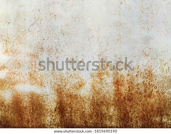 Corroded metal background.\
Rusted grey painted metal wall. Rusty metal background with streaks\
of rust. Rust stains. The metal surface rusted spots.\
Rystycorrosion.