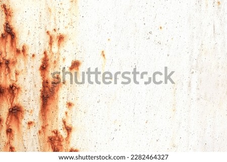 Corroded metal background. Rusted white painted metal wall. Rusty metal background with streaks of rust. Rust stains. The metal surface rusted spots. Rystycorrosion.                    