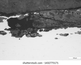 Corrosion and cracking of 2" carbon steel tubing, likely cause is stress corrosion cracking, micrographs