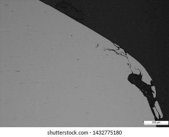 Corrosion and cracking of 2" carbon steel tubing, likely cause is stress corrosion cracking, micrographs