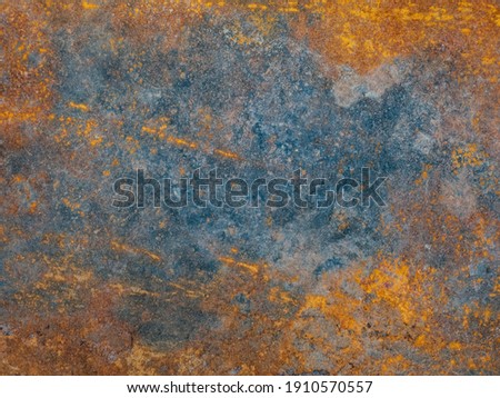 Corrosion. Metal plate with weathered colors and rust. Natural light. Blue and orange metal plate. Old oxidized colorful textured surface. Abstract grunge rusty metallic background for multiple uses.