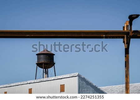Corrosion on water tower and pipes with white rooves