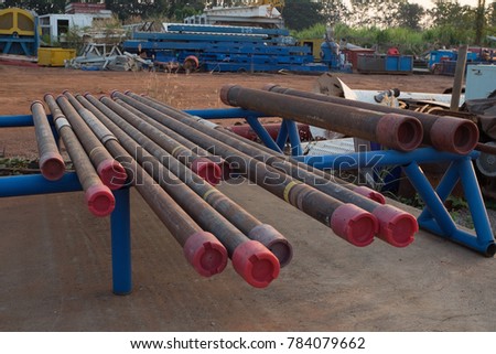 Corrosive pipe thread with rust that prepare for repair by lathe machine,Drillpipe on the rack.