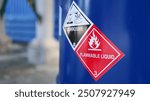 Corrosive warning sign label and flammable liquid warning sign label on the barrel tank. To warn that there are dangerous chemicals in the tank, please be careful.