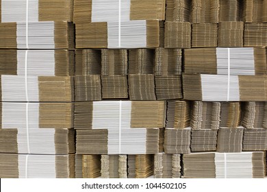 Corrugate cardboard tied with white plastic rope. Corrugated paper single wall. Corrugated fiberboard. Linerboard board. Stack of cardboard boxes. Pleated paper.