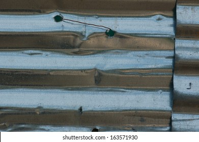 Corrugated Aluminum Construction Fencing. Grungy Metal Background.