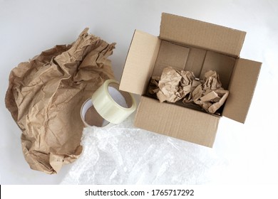 Corrugated Box. Duct Tape, Paper For Packaging Inside The Box. Bubble Wrap. Tools For Packaging Products On A White Background. Packer.