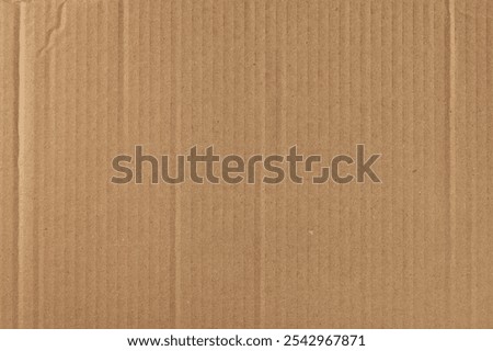corrugated cardboard box outer layer surface background, brown kraft paper with rough fibrous texture, matte neutral tone backdrop wallpaper