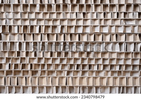 Corrugated Cardboard packing material. Texture of corrugated paper sheets made from cellulose. Natural brown cardboard surface.