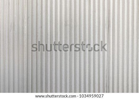 The corrugated grey metal wall background. Rusty zinc grunge texture and background.