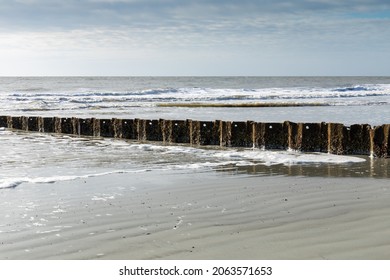 Corrugated Metal Erosion Control Sea Wall On A Beach, Morning Light On A Clear Day, Horizontal Aspect