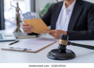 Corruption And Bribery A Judge Takes A Hammer With A Lawyer For Justice. A Businesswoman In A Suit Or A Lawyer Works On Documents, Laws, Advice And Justice Concepts. Illegal Bribery