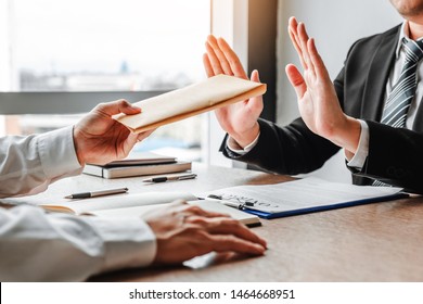 Corruption and Bribery,Businessman manager refusing receive money from Business man passing money dollar bills to deal contract - Shutterstock ID 1464668951