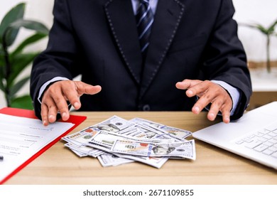 Corruption Concept With Businessman’s Hands Hovering Over Dollar Banknotes
