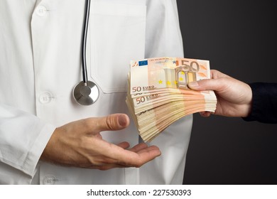 Corruption In Health Care Industry, Doctor Receiving Large Amount Of Euro Banknotes As A Bribe.