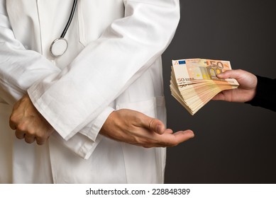 Corruption In Health Care Industry, Doctor Receiving Large Amount Of Euro Banknotes As A Bribe.