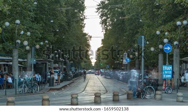 Corso Sempione timelapse, one of the main radial\
boulevards of Milan, directed north-west from Arco della Pace, here\
viewed from Piazza Sempione. Traffic cars and tram. Summer day\
before sunset.