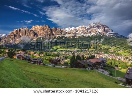 Cortina d'Ampezzo town panoramic view with alpine green landscape and massive Dolomites Alps in the background. Province of Belluno, South Tyrol, Italy.