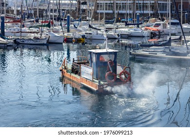 Coruna, Spain - April 15 2021: Local Authority Waste Clearing Boat Spewing Out Toxic Diesel Fumes In La Coruna Harbour